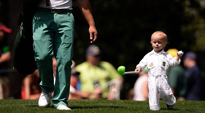 Ryan Moore walks down the hill with his son Tucker during the Par 3 Contest prior the start of the 78th Masters. Moore would win the contest at 6 under, two clear of Kevin Stadler and Fuzzy Zoeller.