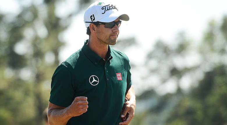 Adam Scott lets out a bit of emotion after making a 5-footer to save par on the 18th hole and secure a 3-under 69 on Thursday at the Masters.