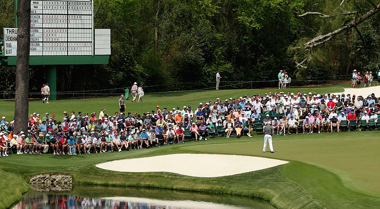 Thomas Bjorn makes a birdie putt on the 16th hole during the second round of the 2014 Masters.