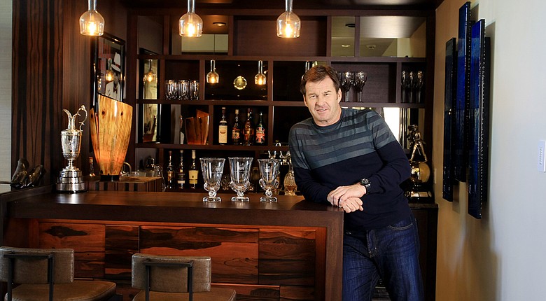Nick Faldo at his home in Winter Park, Fla. with a few of his prized possessions, the Claret Jug and Masters vases.