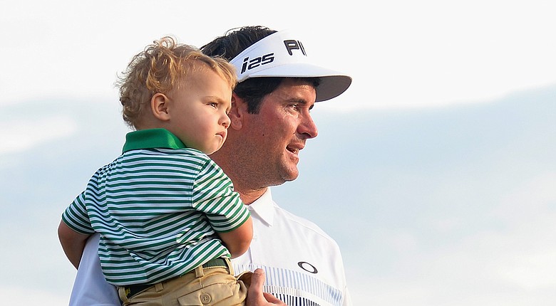 Bubba Watson holds son Caleb after winning the 2014 Masters at Augusta National.