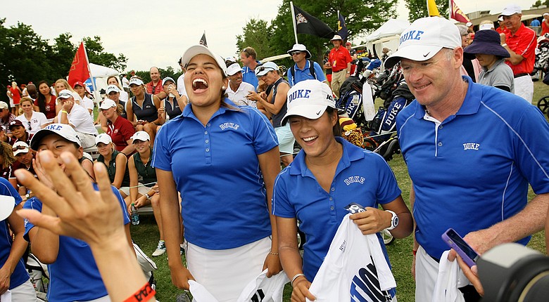 Duke's Alejandra Congrejo and Celine Boutier, center, celebrate alongside with head coach, Dan Brooks, during the final round of the 2014 NCAA Division 1 Women's Golf Championships at Tulsa Country Club.
