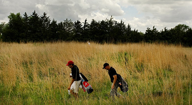 Alabama's Cory Whitsett and Oklahoma State's Talor Gooch walk to the seventh tee during Round 1 of the NCAA Men's Division 1 Championship at Prairie Dunes Country Club in Hutchinson, Kan.