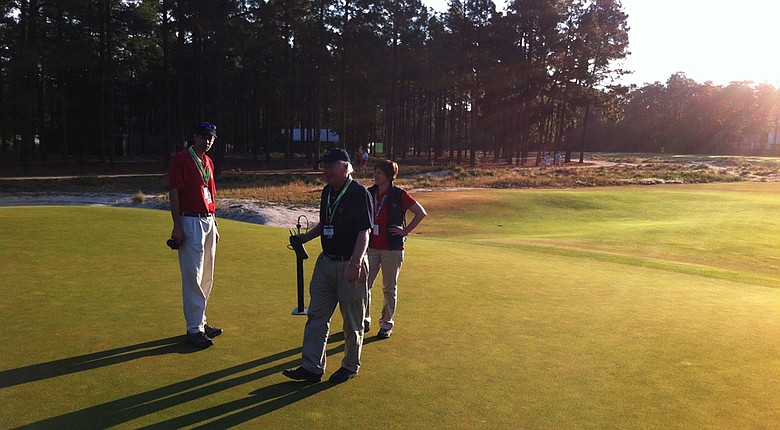 Chris Hartwiger, Pat O'Brien and Kimberly Erusha, all with USGA Green Section, at the seventh green on Wednesday morning at Pinehurst No. 2.