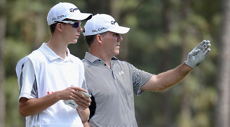 Fran Quinn talks with his caddie Owen Quinn on the 15th tee during the first round of the U.S. Open at Pinehurst No. 2.