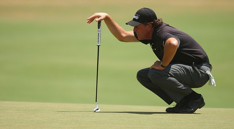 Phil Mickelson lines up a putt on the fifth green during the first round of the U.S. Open at Pinehurst No. 2.