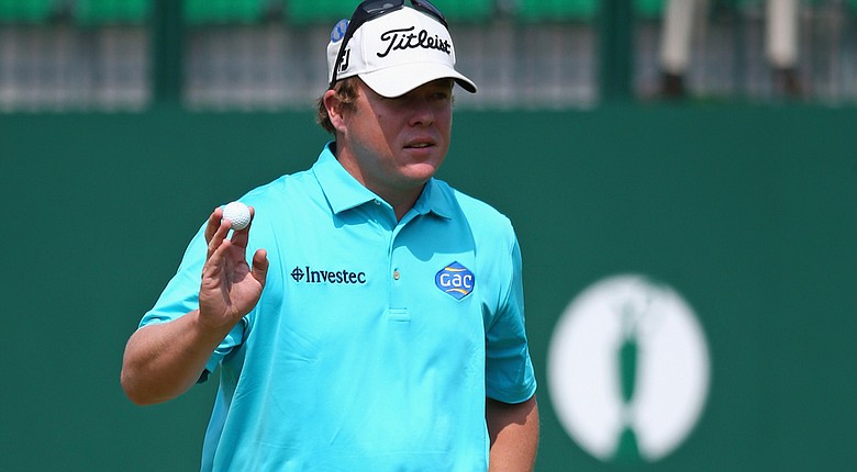 George Coetzee waves to the gallery on the 18th green during the second round of the Open Championship at Royal Liverpool.