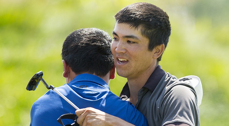 After winning the 2014 U.S. Amateur Public Links, Byron Meth (right) hugs runner-up Doug Ghim at Sand Creek Station Golf Course in Newton, Kan.