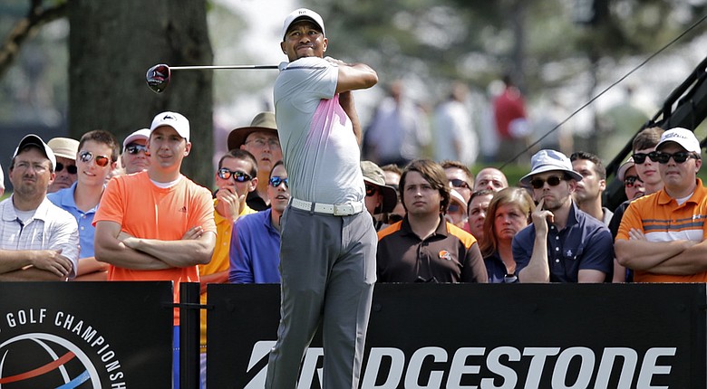 Tiger Woods watches his tee shot on the ninth hole during the first round of the WGC-Bridgestone Invitational.
