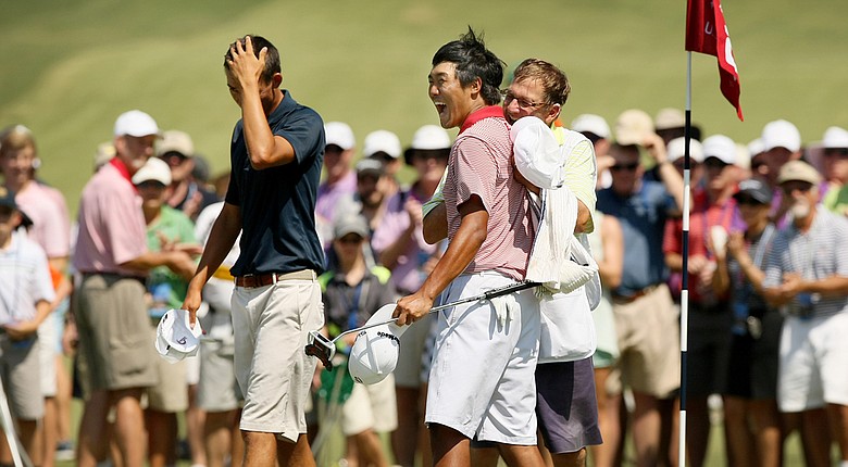 Gunn Yang celebrates his 19-hole victory over Frederick Wedel (left) with his caddie Richard Grice. Yang advances to Sunday's final at the U.S. Amateur, facing Corey Conners at 9 a.m.