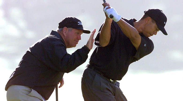 Tiger Woods gets instruction from coach Butch Harmon in 2000. The likelihood of a reunion seems to be a long shot.
