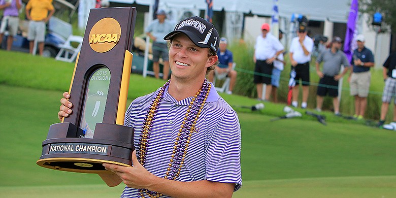 LSU's Brandon Pierce poses for friends and family with the trophy after they won the 2015 Men's NCAA Championship at The Concession in Bradenton, Fla.