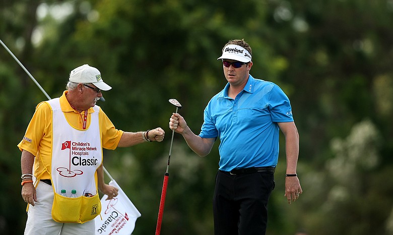 Charlie Beljan with his caddie Rick Adcox at No. 7 on the Magnolia Course during the Children's Miracle Network Hospitals Classic.