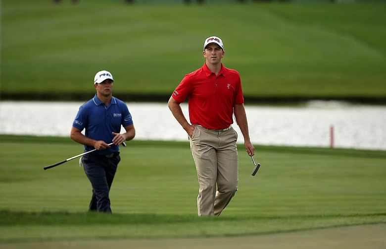 Michael Thompson and Luke Guthrie walk up No. 8 during the Honda Classic on Saturday.