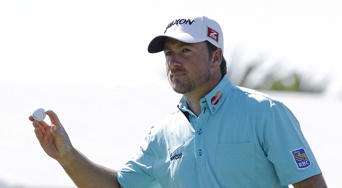 Graeme McDowell acknowledges Thursday's crowd after putting on No. 18th during the first round of the WGC-Cadillac Championship.