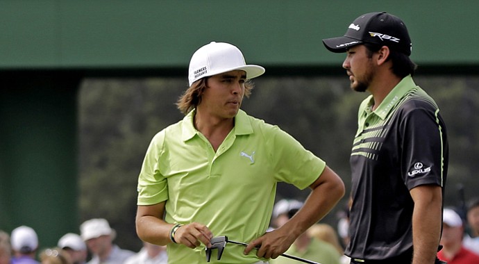 Rickie Fowler talks to Jason Day during the first round of the 2013 Masters.