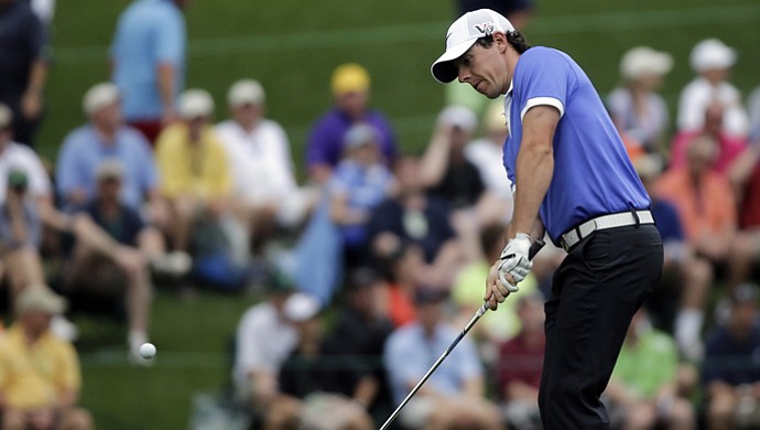 Rory McIlroy, of Northern Ireland, chips to the 15th green during the first round of the Masters.