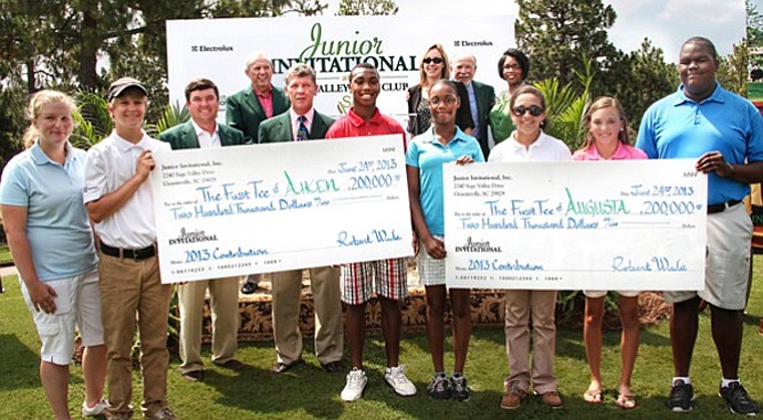 The Junior Invitational at Sage Valley presents the checks to The First Tee.
