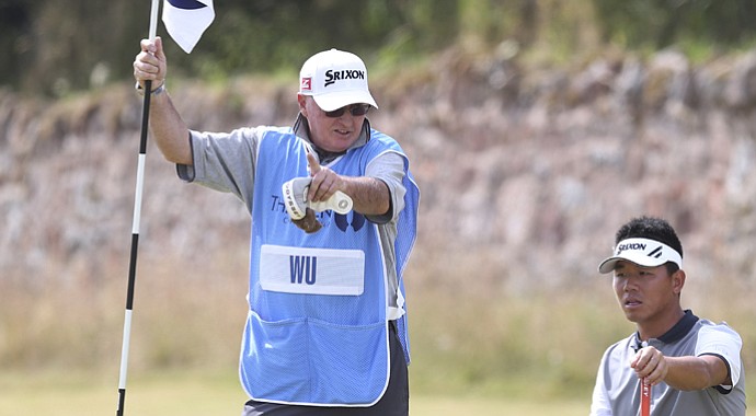 Andy Prodger, former caddie for Nick Faldo, with Ashun Wu during the 2013 British Open at Muirfield.
