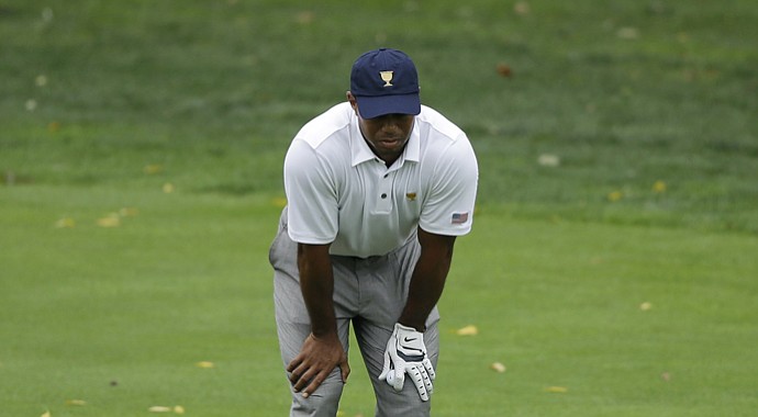 Tiger Woods favors his ailing back between shots during singles play on the final day of the U.S.' 2013 Presidents Cup win at Muirfield Village.