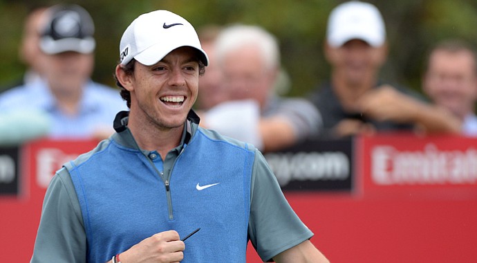 Rory McIIroy laughs as he waits to play his shot off the first tee during Round 2 of the Australian Open.