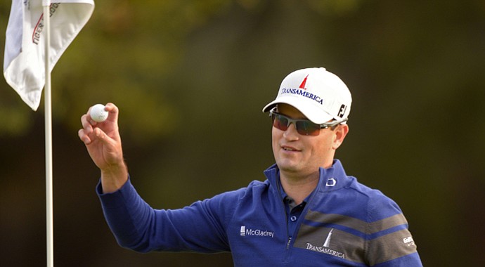 Zach Johnson holds up the ball he holed out with a wedge to force a playoff that he won over Tiger Woods in the 2013 Northwestern Mutual World Challenge.