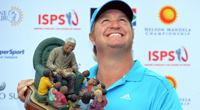 Dawie Van Der Walt looks to the sky as he holds the trophy after winning the Nelson Mandela Championship at Mount Edgecombe CC.