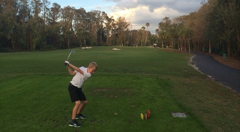Luke, Ian Poulter's son, teeing off the eighth hole of the Palm Course at Walt Disney World Golf Course.