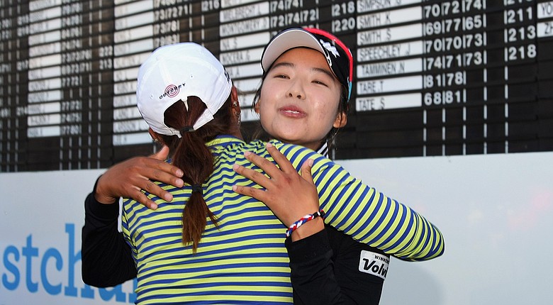 Mi Hyang Lee receives a congratulatory hug from Lydia Ko after the South Korean won the 2014 New Zealand Open.
