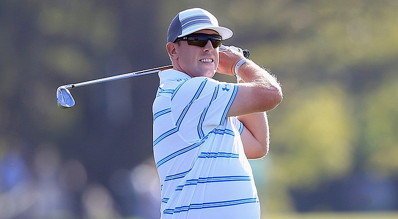 Hunter Mahan survived tough scoring conditions Friday at the WGC-Cadillac Championship and is tied for the lead at 1 under.