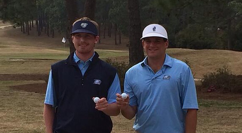 Seniors Hayden Anderson and Will Evans pose with their hole-in-one balls at the Schenkel Invitational.