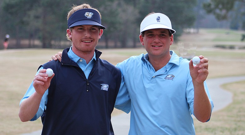 Georgia Southern seniors Hayden Anderson and Will Evans display their hole-in-one balls at the Schenkel Invitational.