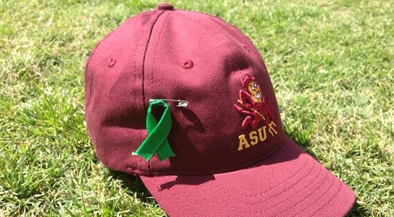 Arizona State players pinned a green ribbon to their hats in honor of Ron Balicki, who is battling cancer.