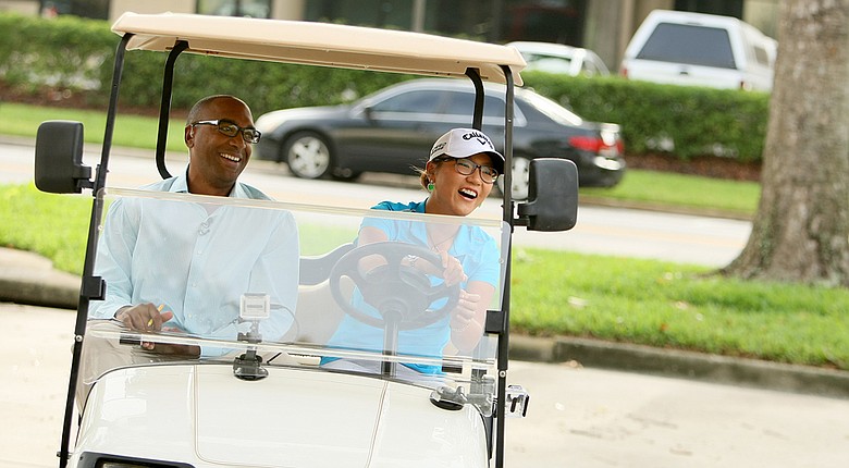 Lydia Ko with Damon Hack as they do a mock driving test in a golf cart at Golf Channel studios in Orlando.