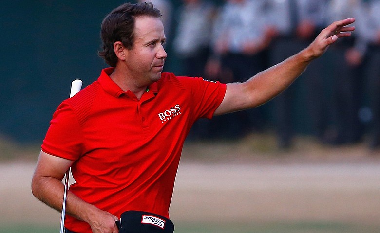 Erik Compton waves as he walks up 18 at Pinehurst No. 2 during Sunday's final round of the 2014 U.S. Open.