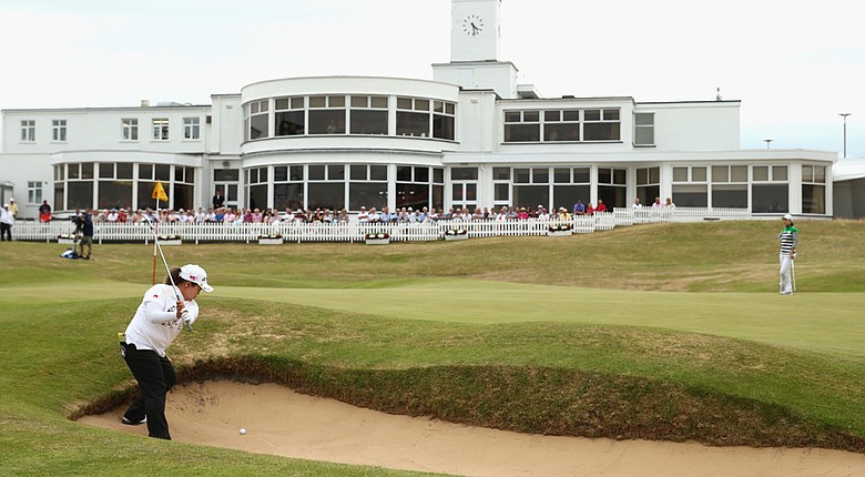 Sun Ju Ahn hits her third shot at the par-5 18th during the third round of the 2014 Ricoh Women's British Open at Royal Birkdale Golf Club in Southport, England. Ahn was given a two-shot penalty after building her stance on this shot from the bunker.