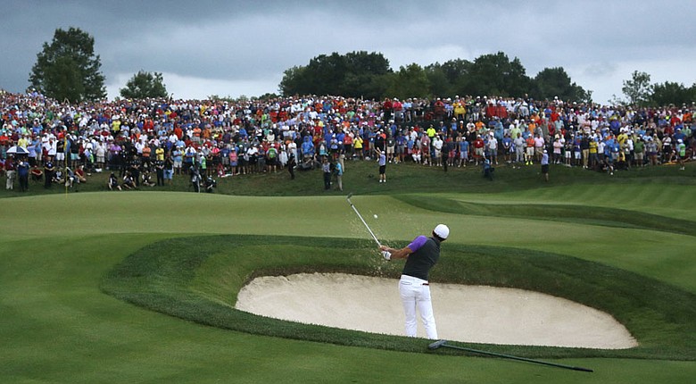 Rory McIlroy hits his third shot at the par-5 18th during the final round of the 2014 PGA Championship. McIlroy and Bernd Wiesberger had hit their second shots into the 18th before Phil Mickelson and Rickie Fowler, both in the pairing ahead, had finished the hole.