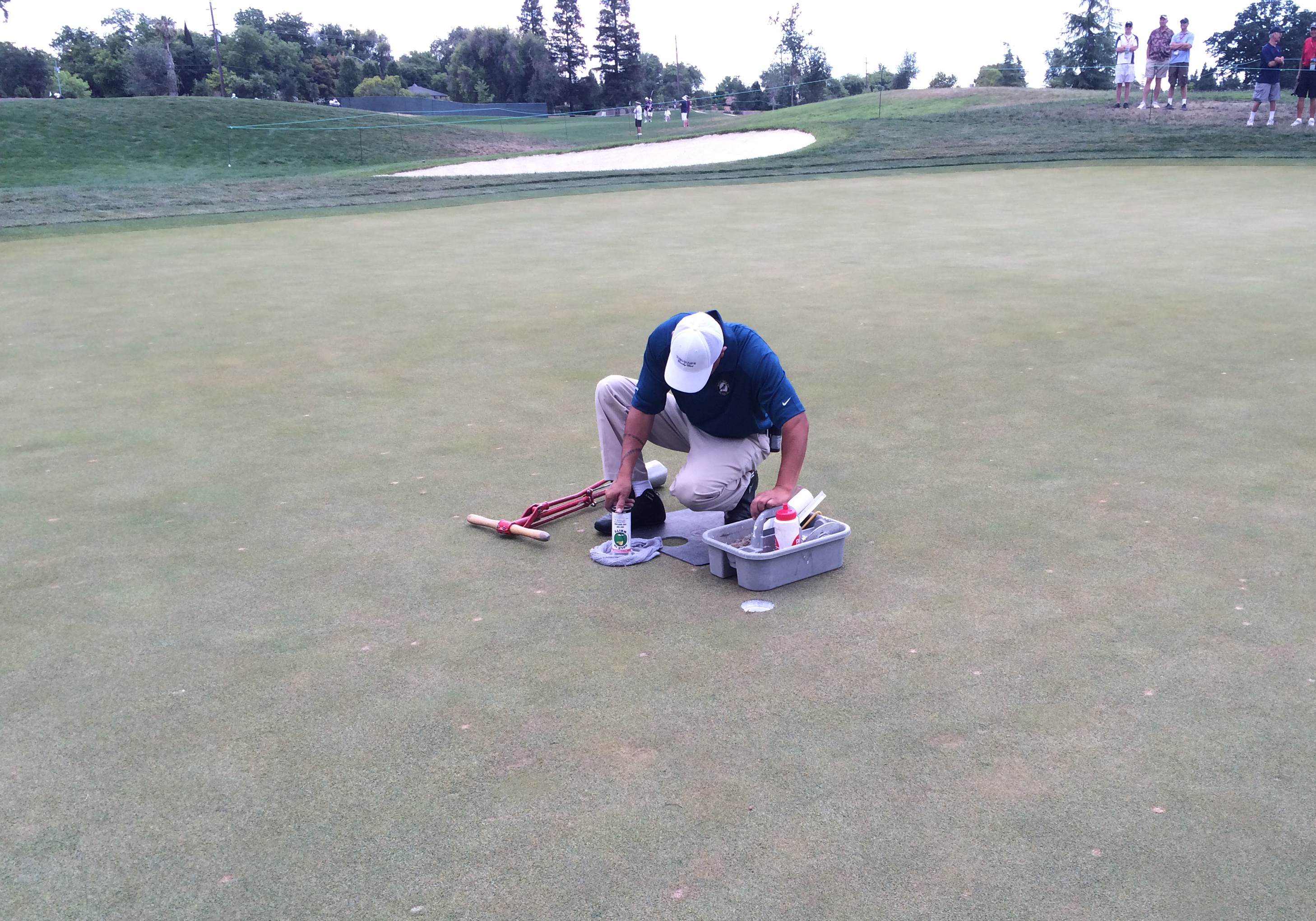 USGA officials try to repair No. 2 at the U.S. Senior Open