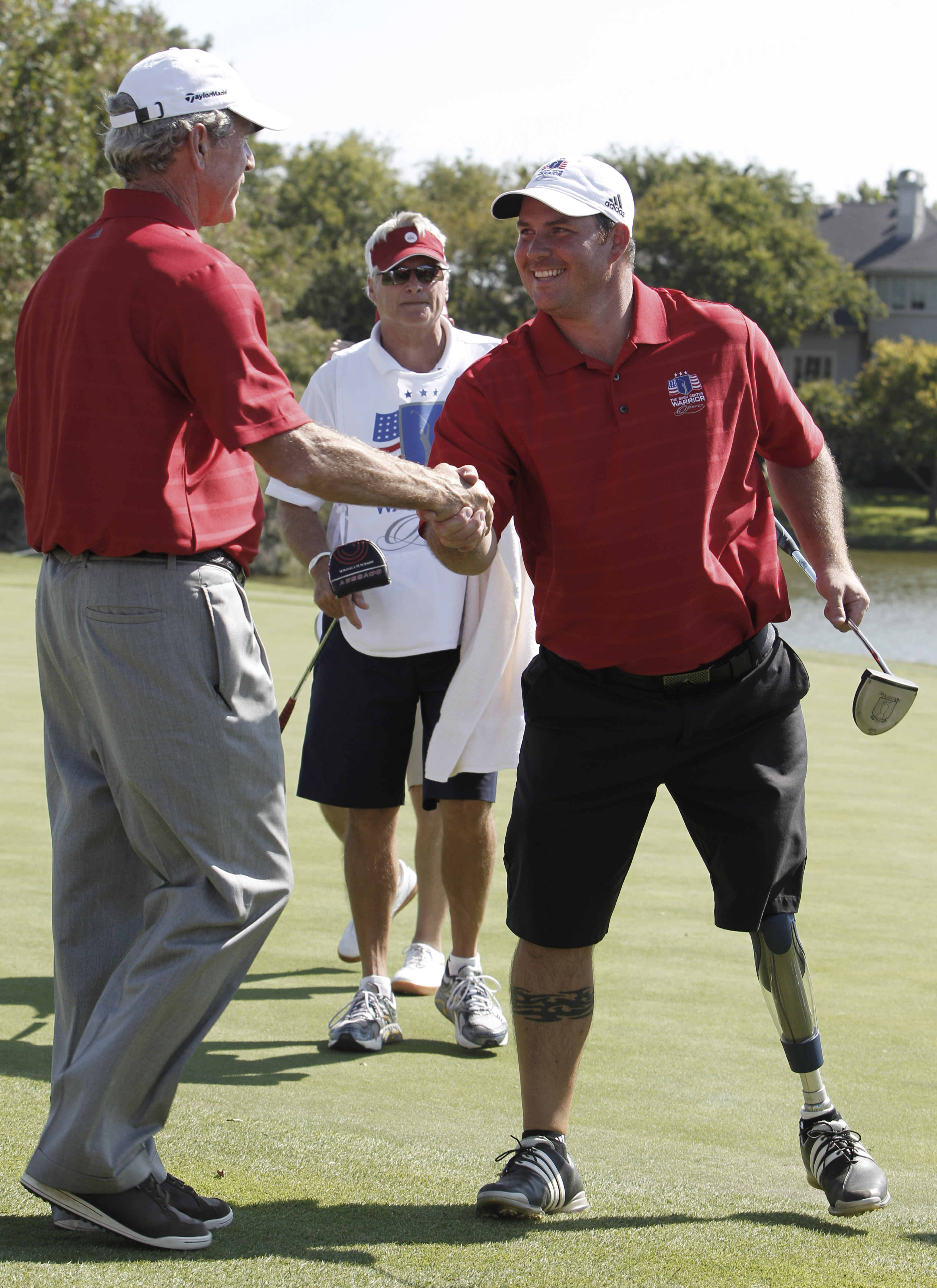 From left: Former President George W. Bush and Chad Pfeifer at the Bush Center Warrior Open in 2012