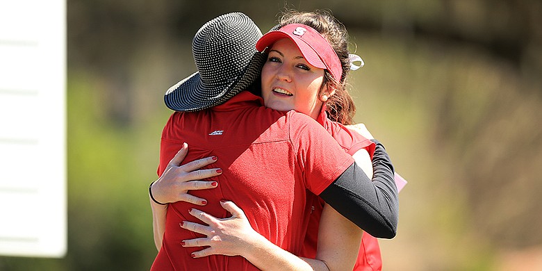 NC State’s Rachael Taylor is hugged by her coach, Page Marsh after she won the SunTrust Gator Women's Invite at Mark Bostick Golf Course in Gainesville, Fla.